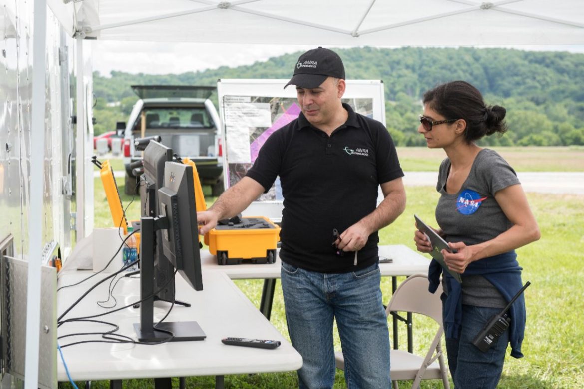 Amit Ganjoo, left, CEO of ANRA Technologies, and Arwa Arweiss, NASA’s Unmanned Traffic Management National Campaign coordinator, watch as the flight paths of unmanned aircraft participating the tests appear on screens displaying a traffic-management software user interface